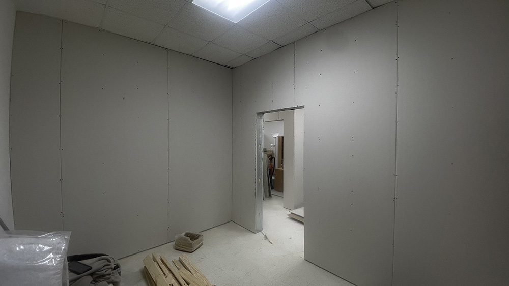 commercial office room with sheetrock panels to be finished